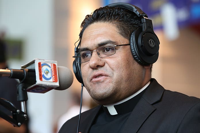 Father Refugio OÃ±ate Melendez, pastor of St. Patrick Church, Norcross, is interviewed by Radio Immaculada. Photo By Michael Alexander