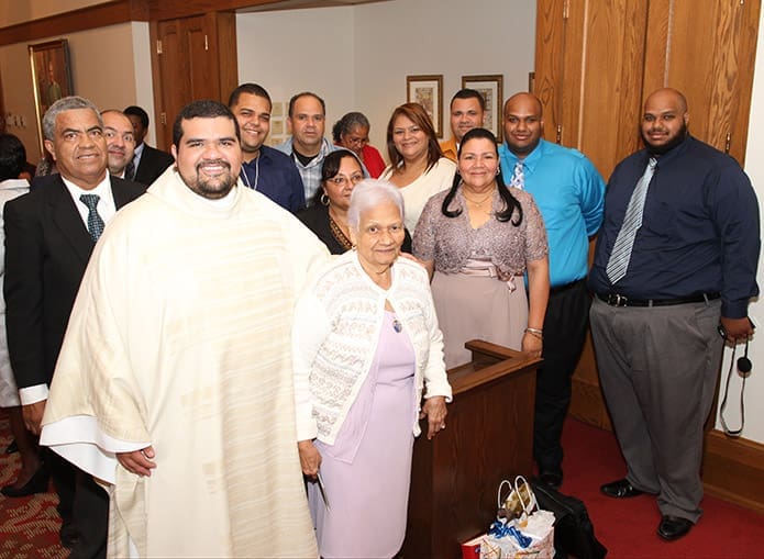After numerous blessings and greetings in the Cathedral of Christ the Kingâs Kenny Hall, Father Luis Alvarez, foreground left, poses with many of his relatives who traveled from Puerto Rico to attend his ordination, including his father Luis, second row, left, and his mother Carmen, second row, third from right. Photo By Michael Alexander