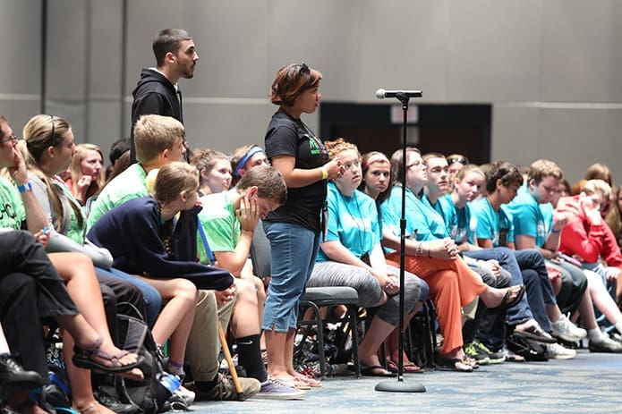 Standing before the microphone, Kaya Allen of St. Margaret Mary Church in Slidell, La., listens to the response after posing a question during the Steubenville Atlanta Conference about how to convince someone God is with them when they are contemplating suicide. Photo By Michael Alexander