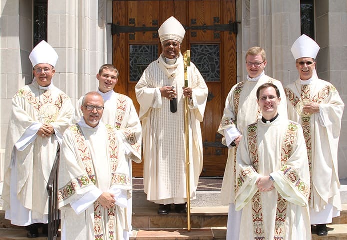 The four new transitional deacons join the three Atlanta bishops on the steps of the Cathedral of Christ the King, Atlanta, following the May 31 ordination. Pictured are (l-r, back row) Bishop David Talley, Rev. Mr. Branson Hipp, Archbishop Wilton D. Gregory, Rev. Mr. Tim Nadolski, Bishop Luis Zarama and (front row, l-r) Rev. Mr. Mark Thomas and Rev. Mr. Brian Bufford. Photo By Michael Alexander