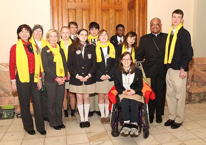Archbishop Wilton D. Gregory, second from right, poses for a photograph with (front row, l-r) Sophia Academy advancement director Cathi Athaide, the schoolâs founding director and head of school Marie Corrigan, teachers and students. Photo By Michael Alexander