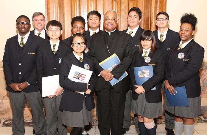 Archbishop Wilton D. Gregory, front row center, poses for a photograph with Cristo Rey Atlanta Jesuit High School students and its president Bill Garrett, back row, left. Photo By Michael Alexander