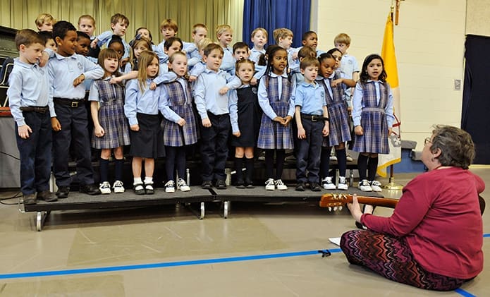 The kindergarten class from St. Thomas More School in Decatur performed the song Lean On Me during the MLK Jr. Youth Celebration. Their teacher, Kathy Merritt, accompanied them on the guitar. PHOTO BY LEE DEPKIN
