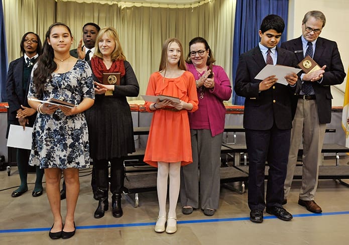 Winners of the annual archdiocesan essay contest include front row, far left, Jillian Bertulfo, Our Lady of the Assumption Catholic School eighth-grader (third place), front row, left center, Elizabeth Steele, Christ the King School sixth-grader (second place), and front row, second from right, George Madathany, St. Thomas More School eighth-grader (first place). PHOTO BY LEE DEPKIN