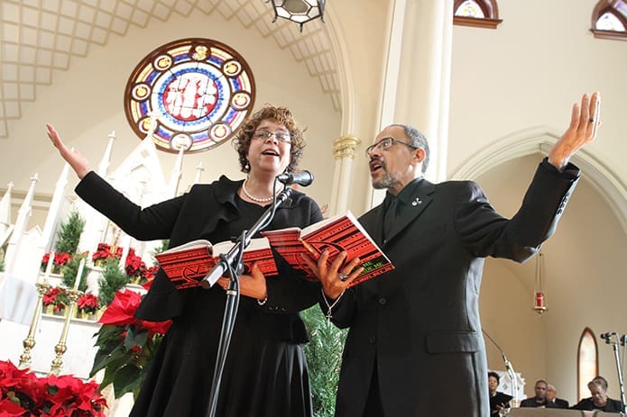St. Anthony of Padua Church choir members Pam Tennell, left and Michael Malcolm lead the congregation in singing the responsorial psalm. Photo By Michael Alexander