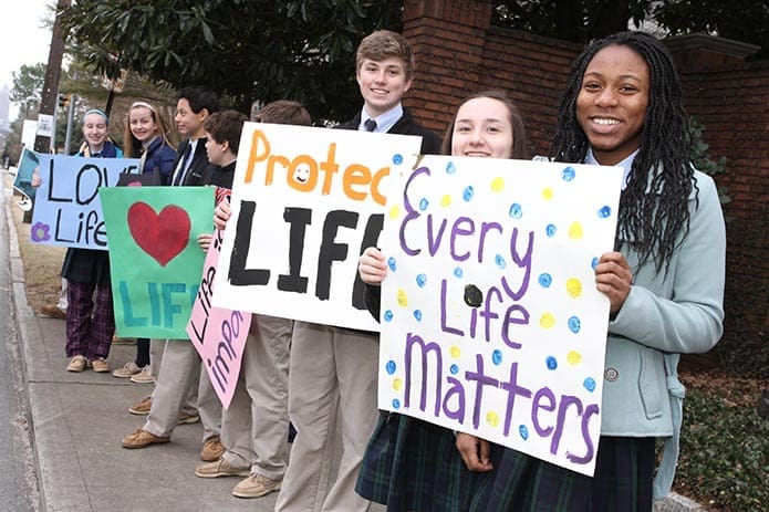 Eighth-graders from St. Joseph School, Marietta, express their convictions about life with signage as they stand along Peachtree Road, Jan. 22. Photo By Michael Alexander