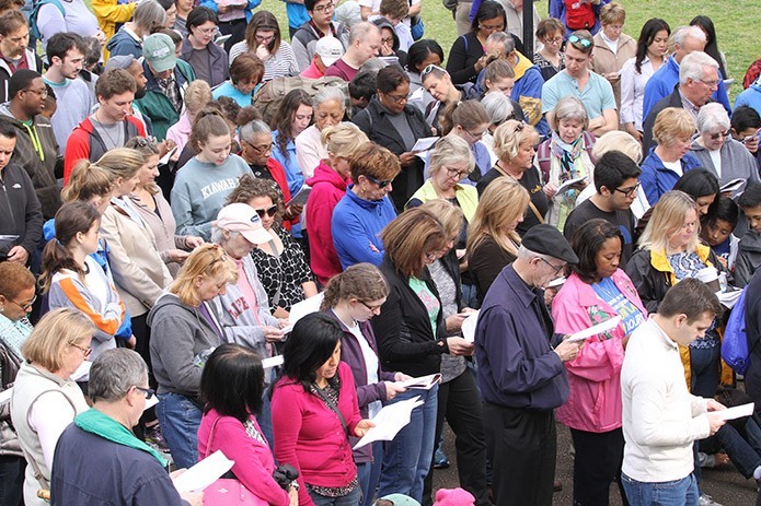 Partakers in the 36th annual Good Friday Pilgrimage through downtown Atlanta pray together during the sixth Station of the Cross (Veronica wipes the face of Jesus) at Hurt Park. Photo By Michael Alexander