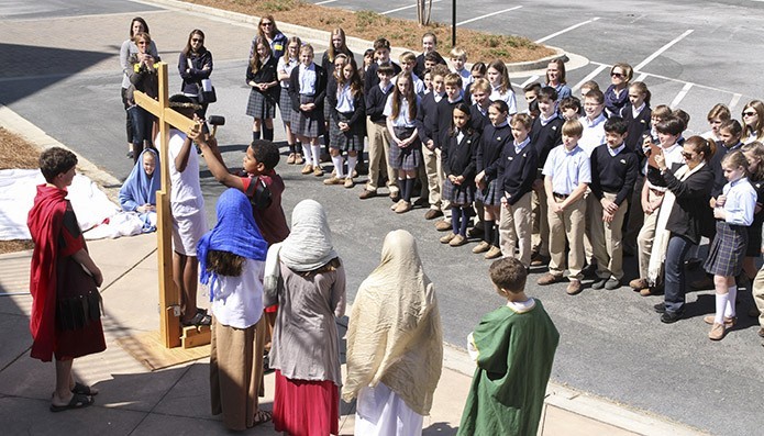 Immaculate Heart of Mary School seventh graders depict the 11th Station of the Cross (Jesus is nailed to the cross) as the school’s sixth graders look on. The version of the stations performed by the students, March 23, was based on the Gospel of Luke. Photo By Michael Alexander