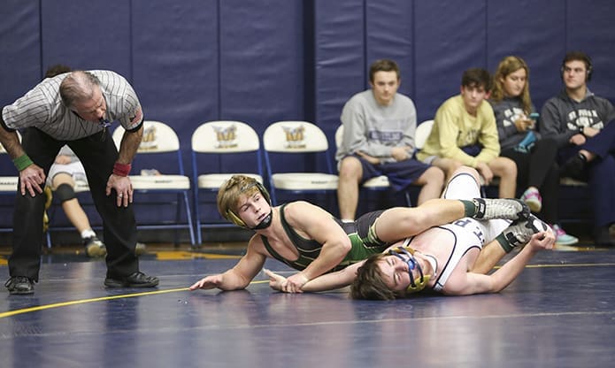 In an effort to finish off Matthew Peragine of St. Pius X High School, Atlanta, Alex Poma, center, of Blessed Trinity High School, Roswell, locks his legs around Peragine in what is called body scissors, and extends the left arm to expose Peragine’s back so he can try and pin him. Poma would win the match in a major decision 10-0. Photo By Michael Alexander