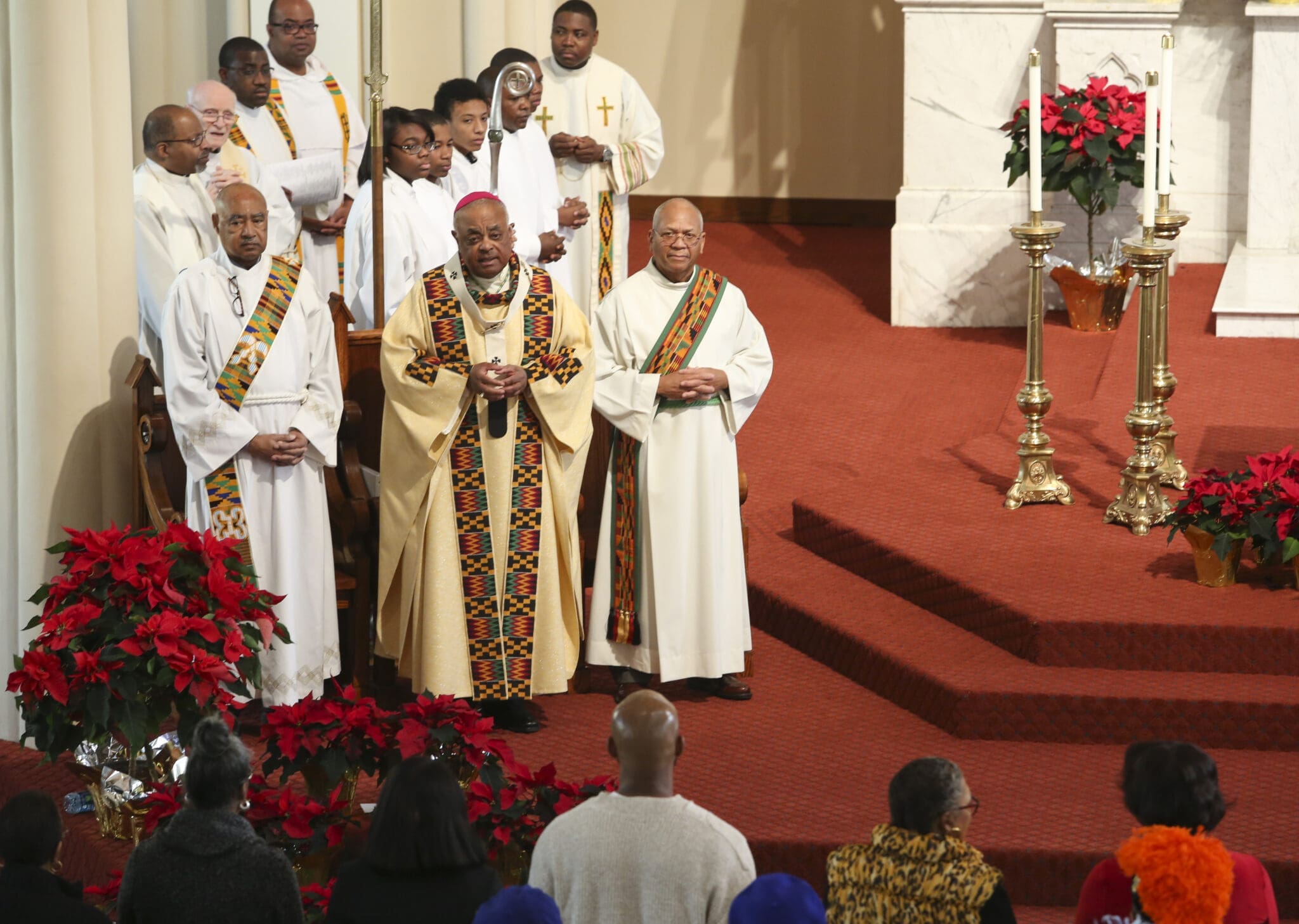Archbishop Wilton D. Gregory, center, the principal celebrant for the Jan. 16 Martin Luther King Jr. Eucharistic Celebration at Atlanta’s Shrine of the Immaculate Conception, gives some opening remarks before the Mass commences. Standing next to the archbishop is Deacon Fred Toca, left, Deacon of the Eucharist, and Deacon Fred Sambrone, right, Deacon of the Word. Photo By Michael Alexander