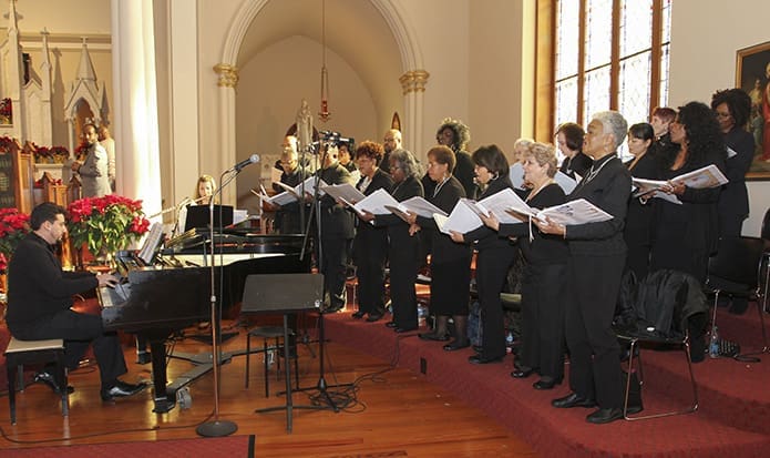 Members of the St. Philip Benezi Choir, under the direction of Nicholas Dragone, seated at the piano, provided music for the Martin Luther King Jr. Eucharistic Celebration. Photo By Michael Alexander