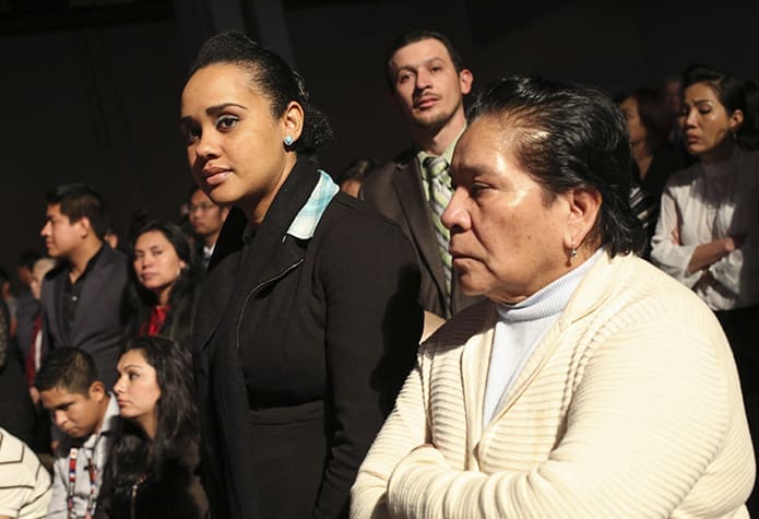 During the presentation of catechumens, Holy Cross catechumen Sorangi Delvillar, left, stands with Teresa Medina, her mother-in–law and sponsor. Photo by Michael Alexander