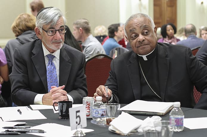 Rabbi Scott Colbert, left, and Archbishop Wilton D. Gregory listen to the comments of a person during the table dialogue portion of the program. The community event was sponsored by the American Jewish Committee Atlanta Regional Office and the Archdiocese of Atlanta. Photo By Michael Alexander