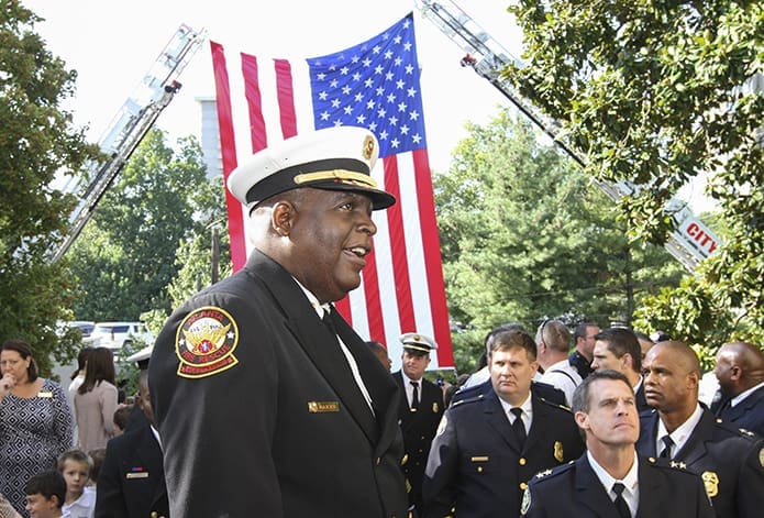 Chief Joel G. Baker of the Atlanta Fire Rescue Department, foreground, converses with other public safety officials as they gather at the entrance to the Cathedral of Christ the King, Atlanta, for the Sept. 8 Blue Mass processional. Photo By Michael Alexander