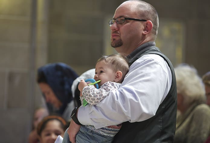 Michael Karrels holds his six-month-old daughter Maria Sophia during the 28th annual Mass for the Unborn at the Cathedral of Christ the King, Atlanta. Karrels and his family attend St. Mary Magdelene Church, Newnan. Photo By Michael Alexander
