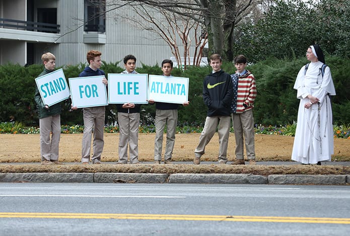 (L-r) Nick Hein, Matthew Graff, Jose Reyes, Franciso Puentes, Connor Hendrix, Ben Mosely, eighth-graders at St. Catherine of Siena School, Kennesaw, join Sister Maria Caeli as they participate in the Jan. 23 Stand for Life along Peachtree Road. Photo By Michael Alexander
