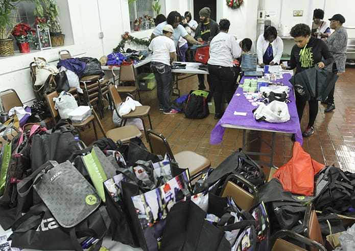 Young adult members of Women Blooming in Season and My Brother’s Keeper Youth Services, Inc., partnered with the Archdiocese of Atlanta to put bags of clothing and hygiene kits together for formerly incarcerated women. The items were donated to the Prison and Jail Ministry. Photo By Michael Alexander