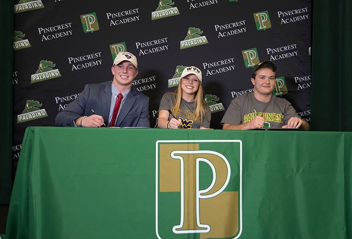 Pinecrest Academy’s Ryan McCarthy, left, and Garrison Winter, right, signed to play football at The Citadel, Charleston, S.C., and Saint Vincent College, Latrobe, Pa., respectively. Ashley Triplett, center, signed to play soccer for West Virginia University, Morgantown, W.Va.