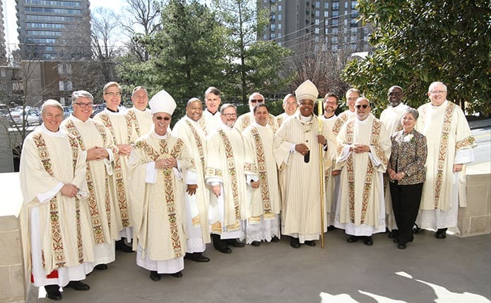 Standing on the plaza by the front entrance to the Cathedral of Christ the King, Atlanta following the rite of ordination to the diaconate are (front row, l-r) Bishop Luis Zarama, new deacons J. Tony King, Randall Ory and Pablo Perez, Archbishop Wilton D. Gregory and Office of the Permanent Diaconate associate co-directors of formation Deacon José Espinosa and Penny Simmons; (back row, l-r) Deacon Steve Swope of St. George Church, Newnan, Deacon Dennis Dorner, director of the Office of the Permanent Diaconate, new deacons Bradford Young, Gregory Orf, John Martin, Leon Roberts, Erik Wilkinson, Charles Iner, Ron Leidenfrost , Lennison Alexander and John Halloran.