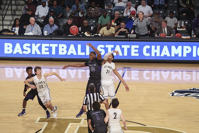 Upson-Lee High School’s Travon Walker (#23) and St. Pius X High School’s Zach Ranson compete for the opening tipoff in the March 10 Class AAAA state basketball championship game at Georgia Tech’s McCamish Pavilion, Atlanta.