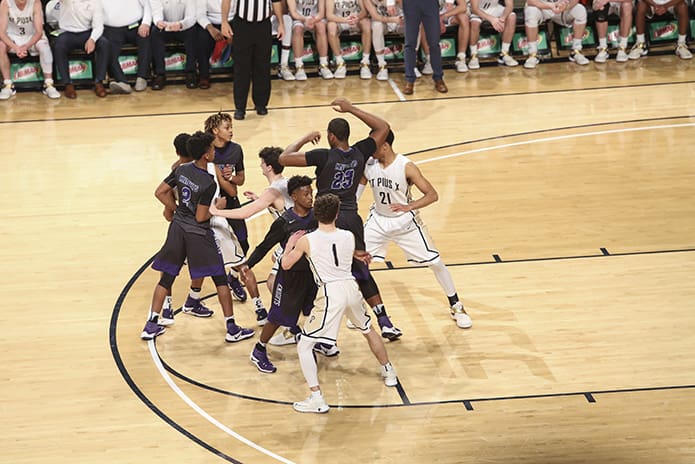 St. Pius and Upson-Lee players jockey for position during an out of bounds play in the game’s closing seconds. St. Pius would have to settle for state runner up after losing to Upson-Lee in the March 10 Class AAAA state basketball final. Photo By Michael Alexander