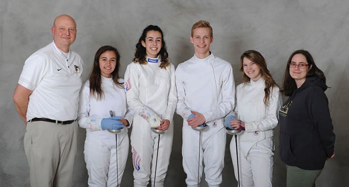 Head coach Chad Morris, far left, and assistant coach Deirdre Donlon, far right, pose for a photograph with seniors fencers (l-r) Juliana Jennings, Isabella Caraballo, Andrew Flowers and Claire Rivard. Charles Insalaca, not present, is the fifth senior on this season's team. Photo Courtesy of Whitelake Studio