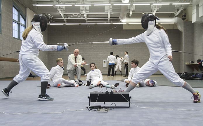 Freshman fencers Jonni Goughnour, left, and Julia Hartman mix it up during practice last December. In the background head fencing coach Chad Morris looks on, as fencers (l-r) Andrew Flowers, Isabella Caraballo and Trip Smith wait their turn. Goughnour and Hartman are two of the teamâs 12 fencers who qualified to compete in the individual fencing championship at Chattahoochee High School in Johns Creek, Jan. 26. Photo By Michael Alexander