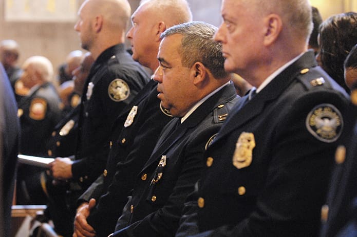 Atlanta Police Capt. Ricardo Vazquez, center, participates with other local first responders and public safety officials at the fourth annual Blue Mass at the Cathedral of Christ the King on Sept. 11. The Mass included a blessing of badges and a saluting of memorial wreaths by leaders from the Atlanta Police and Atlanta Fire Rescue departments. PHOTO BY LAURA MOON.