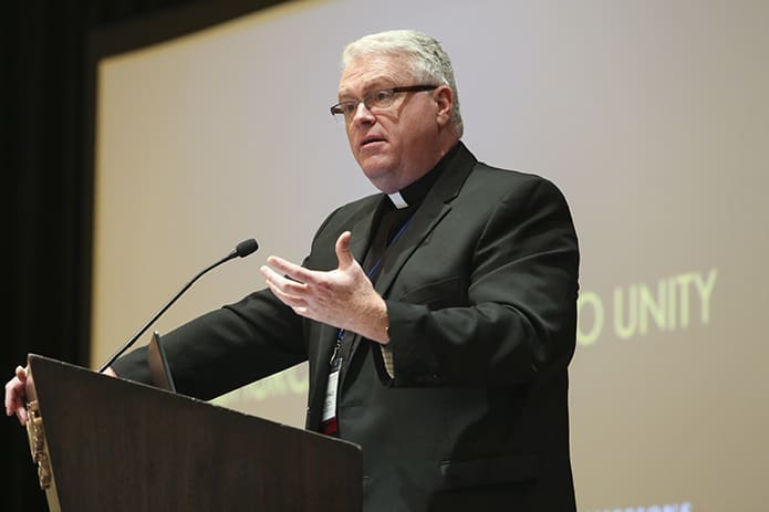 Father Donald J. Rooney, pastor of St. Bernadette Church, Springfield, Va., and director of the Office of Ecumenical and Interreligious Affairs for the Diocese of Arlington (Virginia), was the second plenary session speaker at the National Meeting of Diocesan Liturgical Commissions, Oct. 3. Father Rooney spoke to the attendees about Christian unity. Photo By Michael Alexander