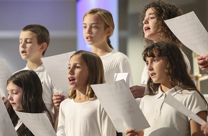 (Clockwise, from bottom left) Kaitlyn Chelko, D.J. Gregory, Amelia Payton, Molly Mings, Suzy Gregory, and Rita Zaccagnino join fellow childrenâs choir members in singing âAll That We Have.â The choir was under the direction of Kim Smith. Photo By Michael Alexander