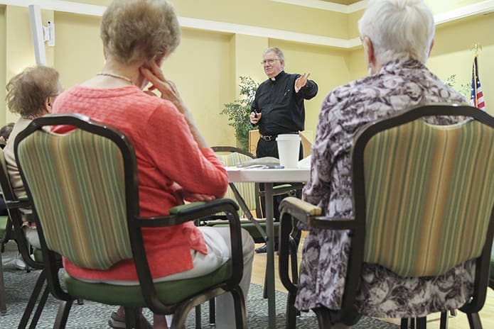 Deacons often take on roles outside their own parishes. In this 2016 file photo, Deacon Michael Bickerstaff of St. Peter Chanel Church, Roswell, conducts a session on church history during a Friday morning Bible study class for a group of senior residents at neighboring St. George Village. Photo By Michael Alexander