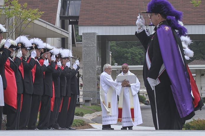 Deacon Ray Egan, background, left center, marked his 25th anniversary as a deacon two years ago. He is currently assigned to St. Jude the Apostle Church in Sandy Springs. Deacon Egan is also the director for the Office of Catholic Cemeteries, which includes overseeing the restoration of historic rural Catholic cemeteries. Photo By Michael Alexander