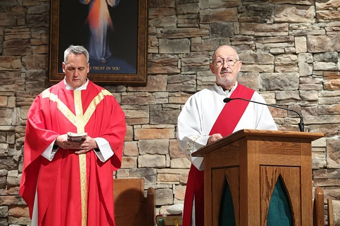 Deacon Evelio Garcia-Carreras, right, leads the general intercessory prayers during 9 a.m. Mass on the feast of St. Josaphat, Nov. 12, at St. Stephen the Martyr Church in Lilburn. Standing to the left is Father Brian Lorei, pastor of St. Stephen the Martyr Church. Photo By Michael Alexander