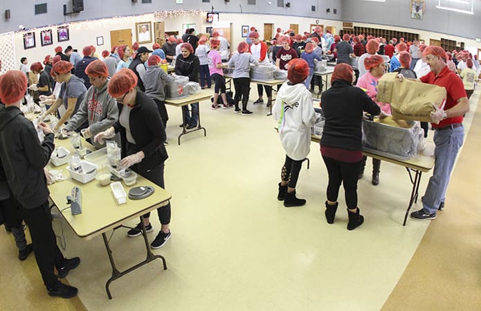 Over the course of the five-hour Catholic Relief Servicesâ Helping Hands event at Holy Trinity Church, Peachtree City, some 600 people took part. It was the sixth year for the parish and this year they had a goal of packing 100,000 meals for Burkina Faso. Photo By Michael Alexander