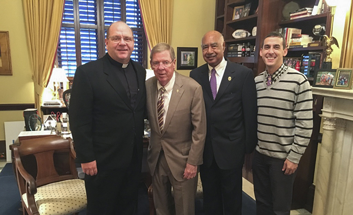 (L-r) Father Victor Galier, pastor of St. Anthony of Padua Church, Atlanta, Georgia Senator Johnny Isakson, Deacon Frederick Toca of Most Blessed Sacrament Church, Atlanta, and Michael Trujillo, relationship manager for Catholic Relief Services (CRS), U.S. Southeast Region, pose for a photo during lobbying efforts on behalf of CRS by Trujillo, Toca and Galier in October of 2017.