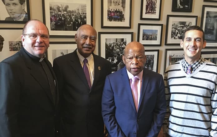 (L-r) Father Victor Galier, pastor of St. Anthony of Padua Church, Atlanta, Deacon Frederick Toca of Most Blessed Sacrament Church, Atlanta, Georgia Congressman John Lewis and Michael Trujillo, relationship manager for Catholic Relief Services (CRS), U.S. Southeast Region, pose for a photo during lobbying efforts on behalf of CRS by Trujillo, Toca and Galier in October of 2017.