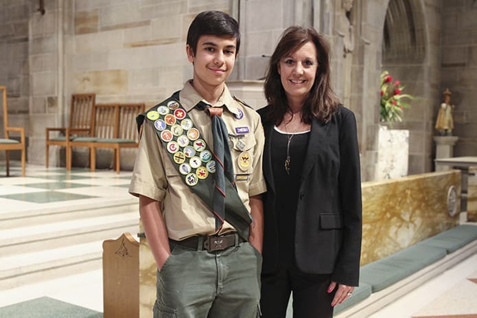 Thirteen-year-old Nicholas Hasnain from St. Monica Church’s Troop 827 joins his mother, Jill, for a post Mass photograph. Nicholas was one of four recipients of the Ad Altare Dei emblem from his parish. Photo By Michael Alexander