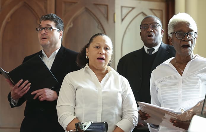 (Clockwise from bottom right) Enid Morgan, Janis Anderson, Carlos Rivera and Leon Daughrity, four of the 19 choir members from St. Philip Benezi Church, Jonesboro, provided music for the Dr. Martin Luther King Jr. Eucharistic Celebration. The choir was under the direction of Buddy Teague. Photo By Michael Alexander
