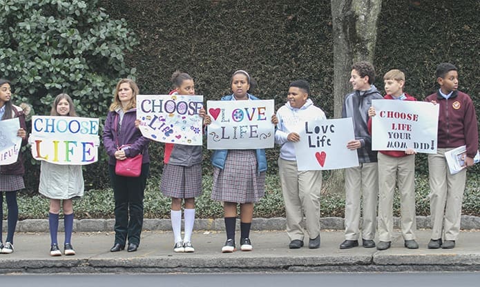 Seventh-grade members of St. John Neumann Regional School’s Students for Life club join Teresa Sullivan, third from left, the school’s advancement director, as they participate in the Jan. 22 Stand for Life Atlanta along Peachtree Road. The club is open to seventh and eighth-graders. Photo By Michael Alexander