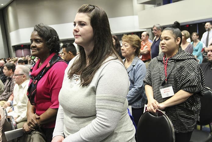 (Counter-clockwise, from foreground right) Lacy Stevens, 24, and Cristal Medina, 34, from St. Michael the Archangel Church, Woodstock, stand during the presentation of catechumens in the Thomas Murphy Ballroom at the Georgia World Congress Center, Atlanta. Stevens and Medina are standing with their respective godparents, Alice Pope and Barbara Parsons. Photo By Michael Alexander