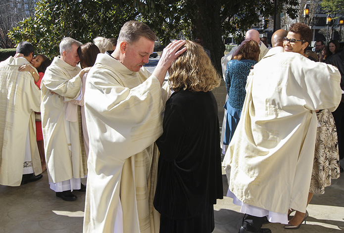 When the Archdiocese of Atlanta's newest permanent deacons administered first blessings to their waiting spouses on the plaza by the front entrance to the Cathedral of Christ the King, Atlanta, the moment was followed by joy in the form of hugs and kisses. Photo By Michael Alexander