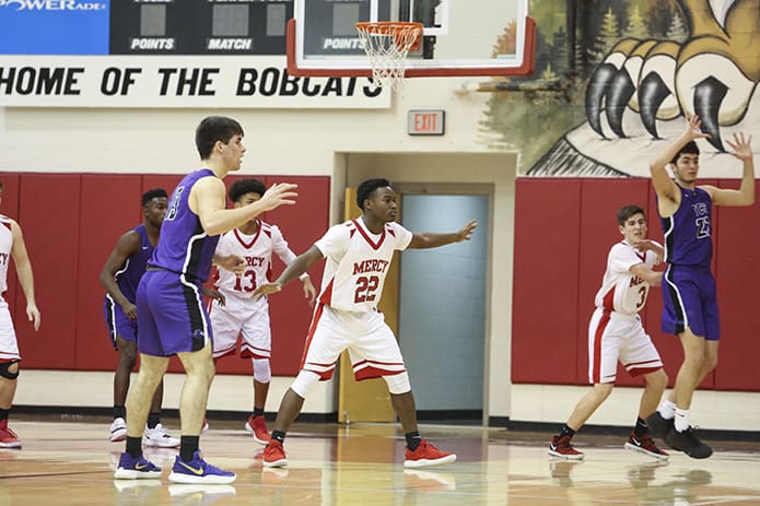Our Lady of Mercy senior Jais Toles (#22) stands on the front end of the team's two-three zone. Toles was one of five basketball seniors recognized at halftime during the school's Feb. 1 Senior Night. Photo By Michael Alexander