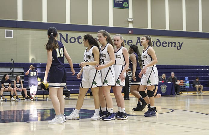 (Second from left, l-r) Notre Dame Academy forwards Stephanie Hernandez and Jacqueline Gilbertson, and guards Amelia Doss and Sydney Whalen, line up for an out-of-bounds play during the second period of the game. Photo By Michael Alexander