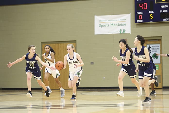 Notre Dame Academy guard Amelia Doss (#4) leads a fast break during the final period of the game. Doss scored six points. Photo By Michael Alexander