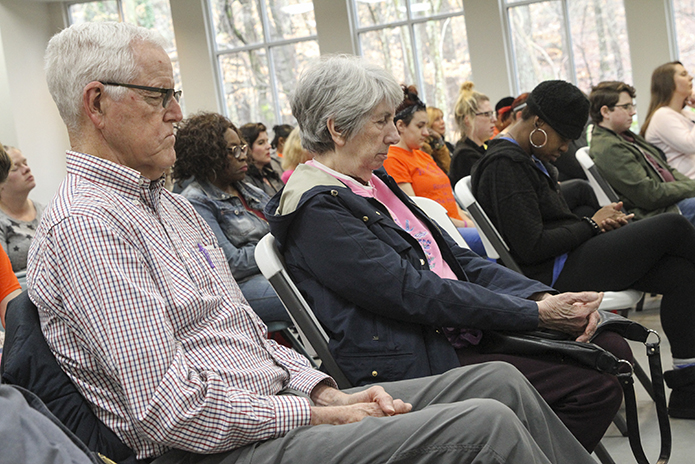(L-r) Joe and Mary Jean Goode, St. Jude the Apostle Church and Pax Christi members, bow their heads and close their eyes as Rabbi Spike Anderson of Temple Emanu-El in Sandy Springs leads a prayer. A group of some 75 people, consisting of clients, staff and supporters of Mary Hall Freedom House gathered at Rivercliff Lutheran Church, Sandy Springs, for a Feb. 22 interfaith prayer vigil. Photo By Michael Alexander