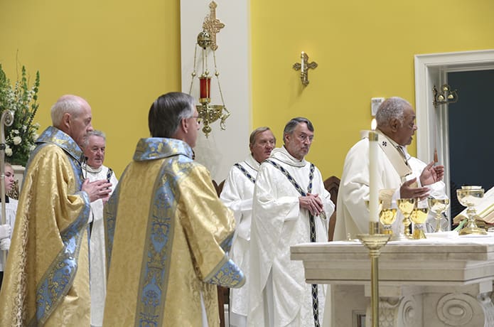 During the Liturgy of the Eucharist, Father Darragh Griffith, second from left, the current pastor of Mary Our Queen Church, Peachtree Corners, Father David M. Dye, second from right, senior priest and former administrator of Mary Our Queen Church, and Father Francis âButchâ Mazur, third from right, the last pastor of St. Gerard Church, Buffalo, New York, join their brother clergy on the altar, including Archbishop Wilton D. Gregory, right, the principal celebrant. Photo By Michael Alexander
