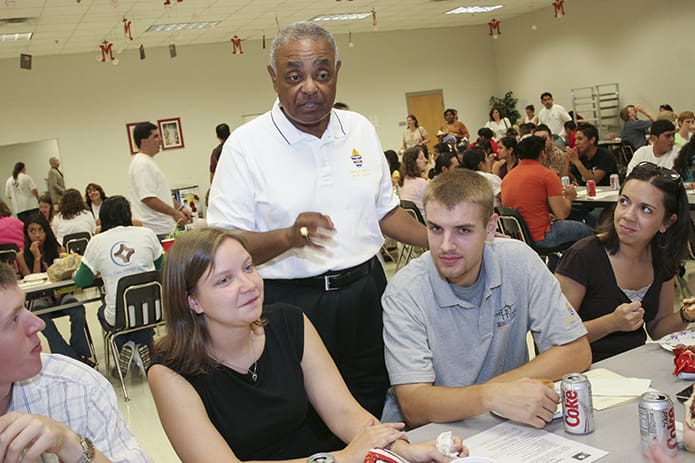Archbishop Wilton D. Gregory converses with young men and women following a Young Adult Jubilee Mass at Our Lady of Mercy High School, Fayetteville, in August 2006. Photo By Michael Alexander