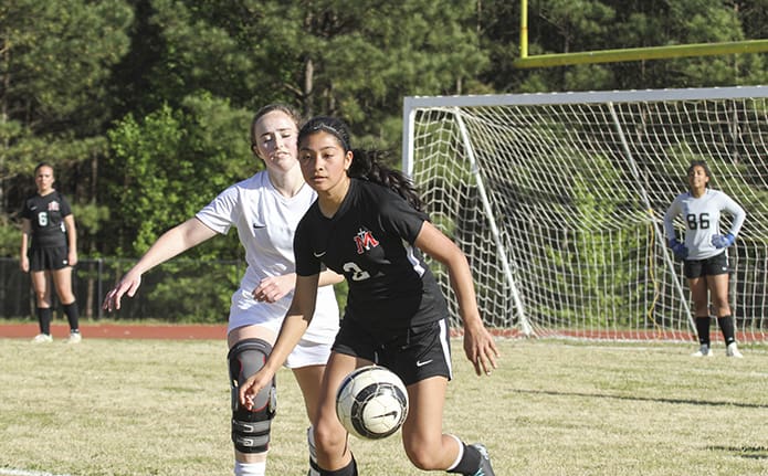 Our Lady of Mercy High School's Abigail Barrantes (#2) displays her role as an attacking midfielder during the first half of the March 27 soccer match against Atlanta Classical Academy. Our Lady of Mercy would lose 5-0 on their home field. Photo By Michael Alexander