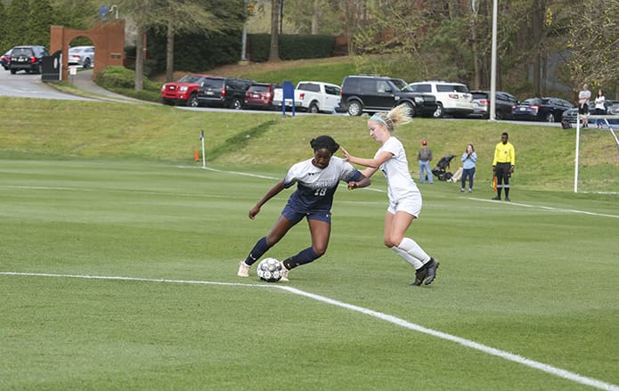 Marist School sophomore midfielder Annika Bryant, left, performs some fancy footwork around the ball as opposing St. Pius X freshman midfielder Emmy Glenn unsuccessfully attempts to steal it from her. Photo By Michael Alexander