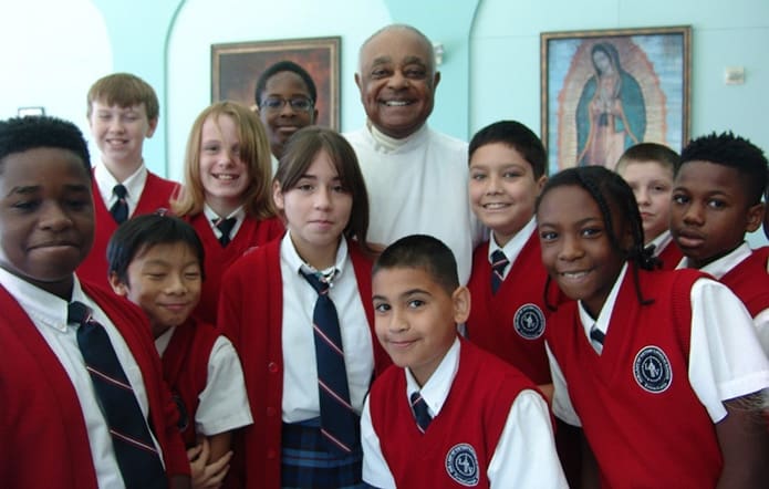 Group picture time! Archbishop Gregory smiles with students at Our Lady of Victory School, Tyrone.
